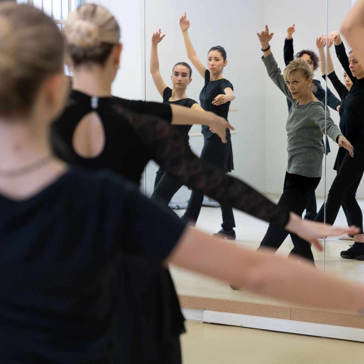 A ballet teacher during a lesson in a dance hall
