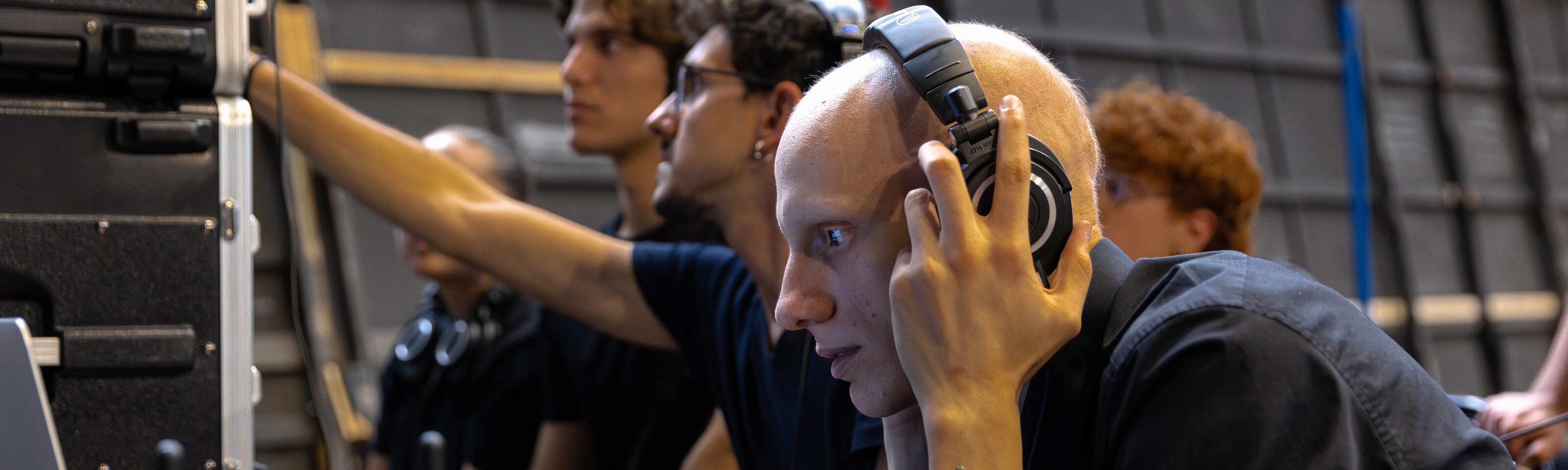 sound technicians at work in consoles with headphones