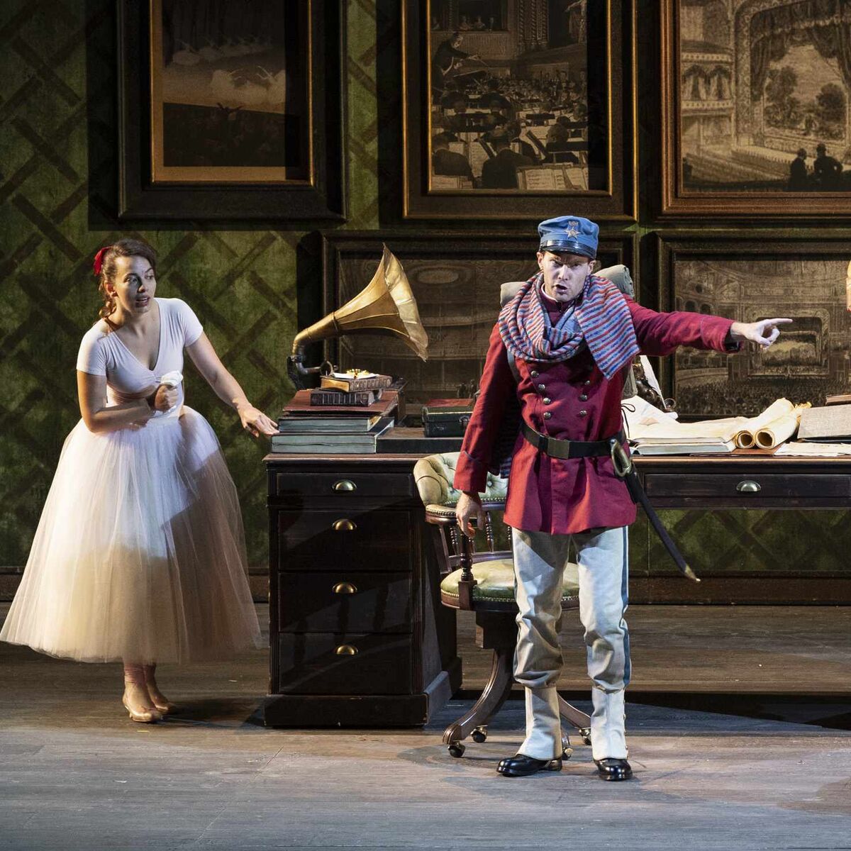  Two artists on stage during a show, with costumes and sets