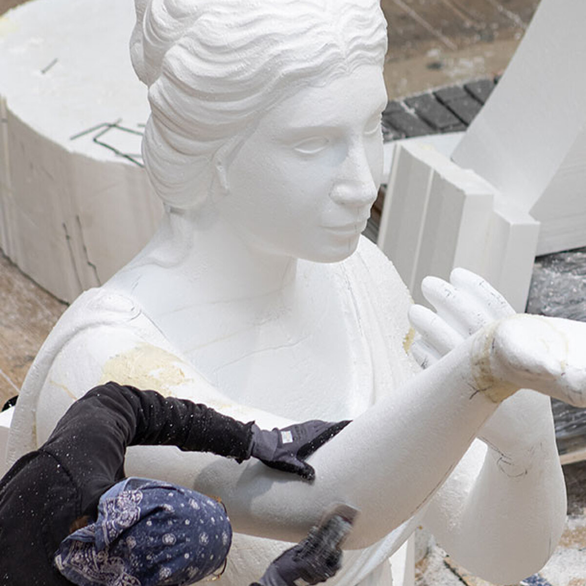 A set designer building a sculpture for theatre in polystirine