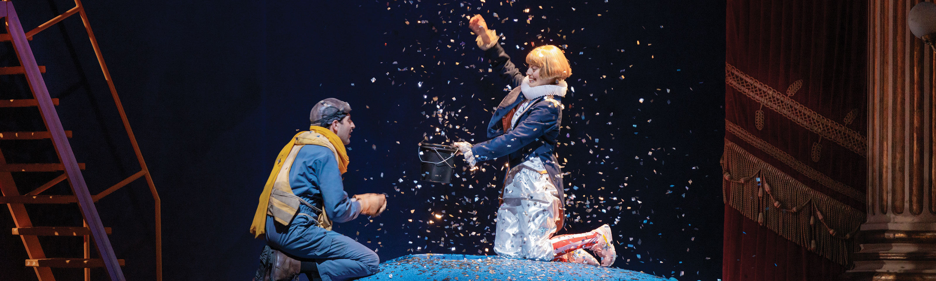 Opera singers on stage in costumes with props and sets