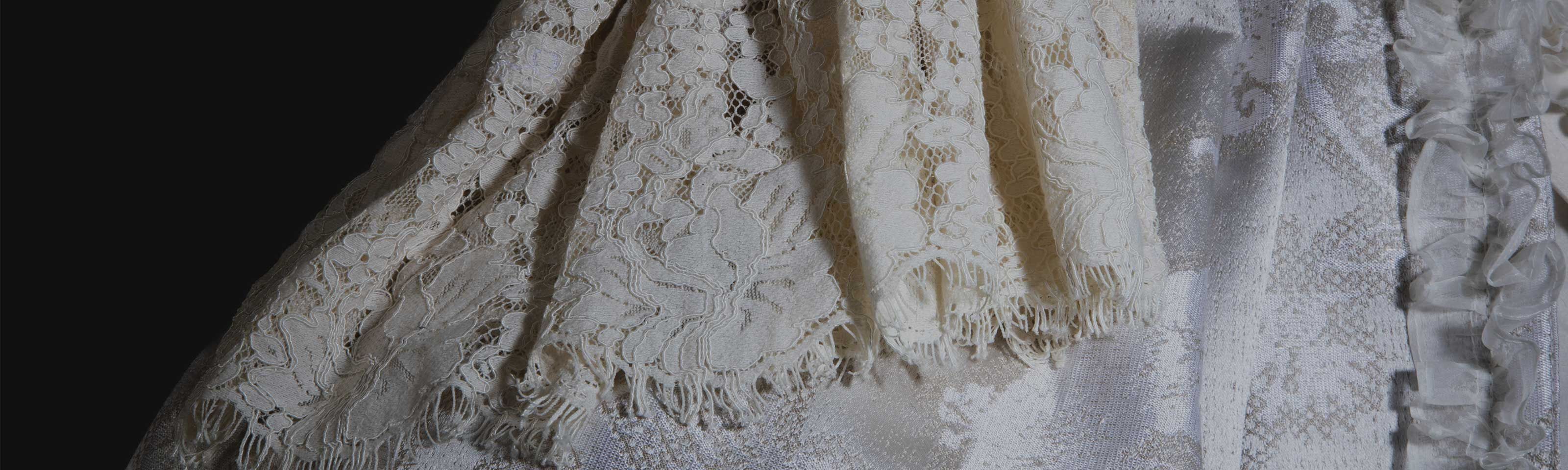 detail of draped lace sleeve on mannequin