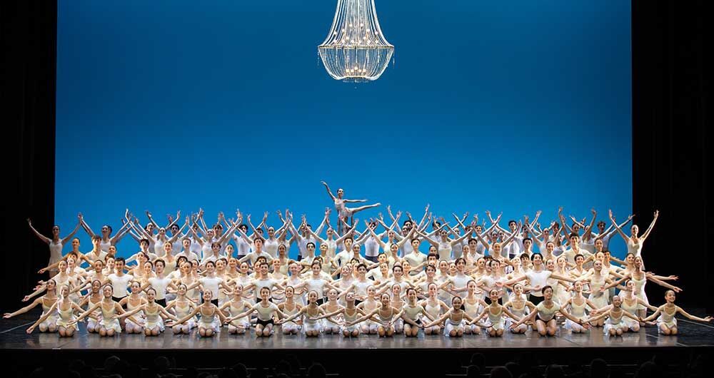 ballerine e ballerini schierati in palcoscenico